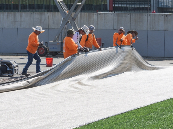 Workers utilize reclaimed Materials in field renovation